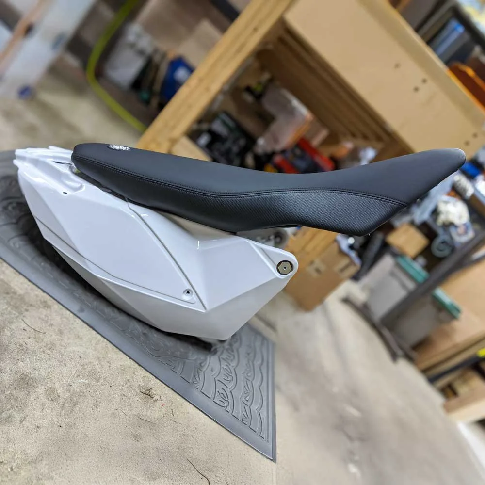 Seat Concepts KTM 690 Enduro R XL Seat with the KTM 450 Rally Tank on a workshop floor